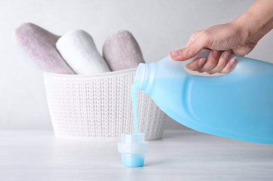 pouring laundry detergent fabric softener