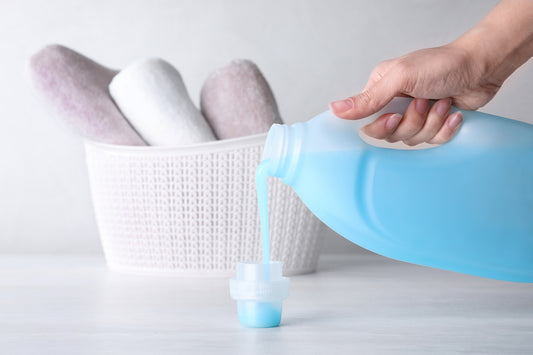pouring laundry detergent fabric softener
